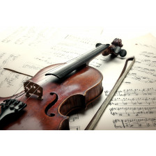 Old scratched violin with sheet music