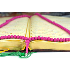 Holy Koran with a rosary praying beads